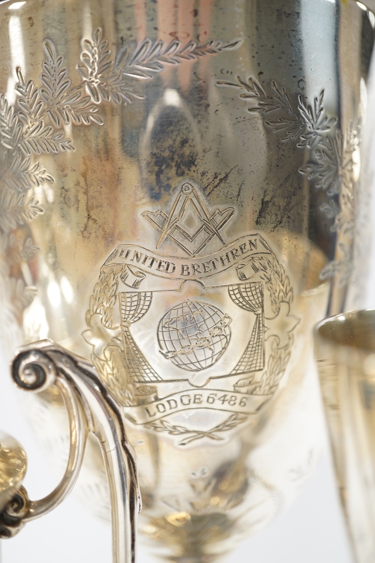 A Victorian engraved silver presentation goblet, with Masonic inscription, London, 1880, 19.5cm, together with a modern silver presentation goblet and a silver two handled presentation trophy cup and cover, 20.2oz. Condi